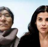 Fábio Nakagawa e Regiane Nakagawa durante entrevista, ambos com aparência séria e cenário de fundo claro.