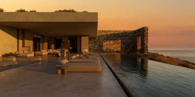 Design regenerativo na Grécia: vista de uma moderna construção com piscina de borda infinita, ambiente ao pôr do sol